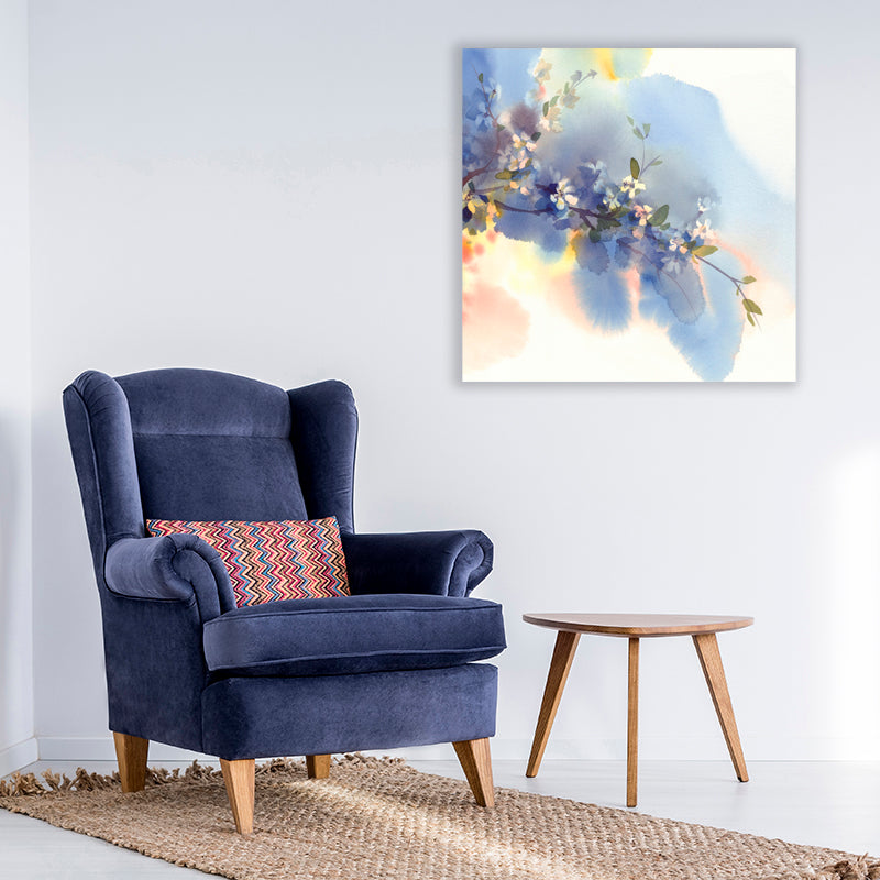 Art print capturing delicate white flowers contrasting against an indigo blue sky, beside a navy blue velvet armchair. 