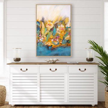 Abstract floral canvas artwork in the rich coastal colours of turquoise and coral, displayed above a white Hamptons-style sideboard.