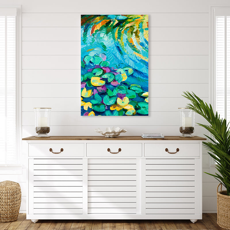 Canvas art print of an aqua blue lily pond with green and yellow lily pads, in a white tropical-style interior.
