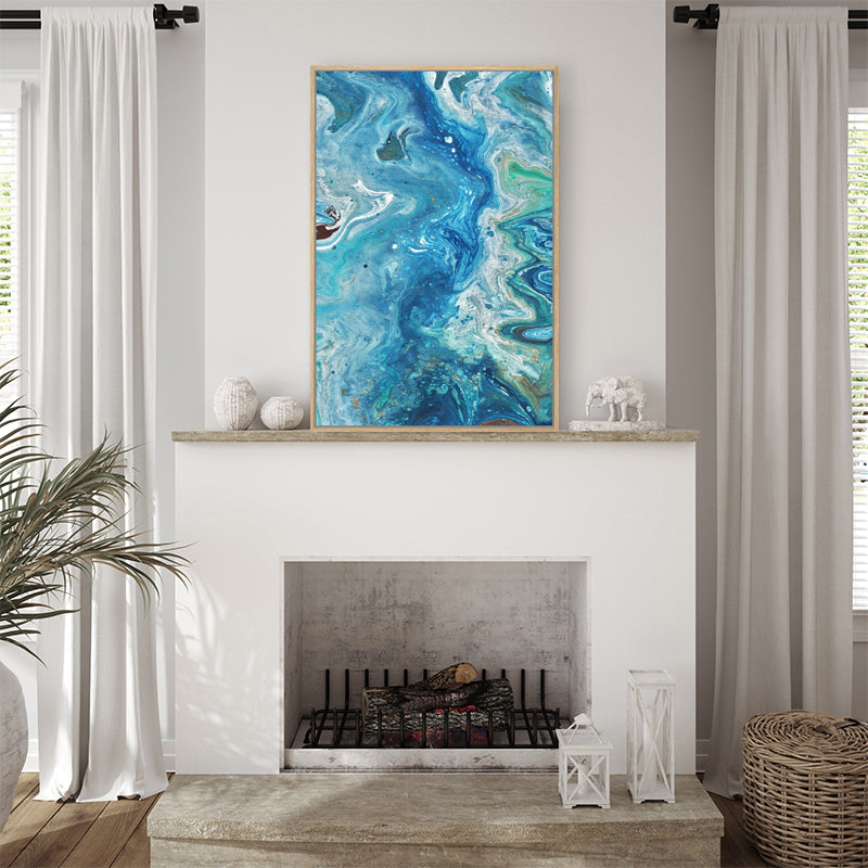 Aqua framed canvas art print, evoking imagery of the ocean and its tides, displayed in a coastal-style living room.