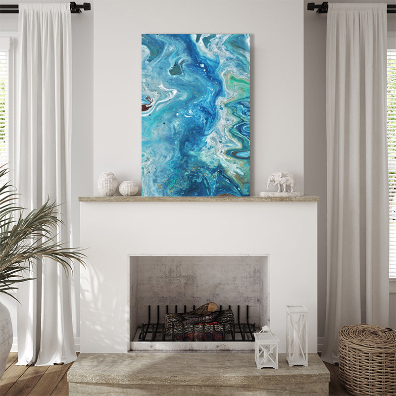 Abstract aqua canvas art print, evoking imagery of the ocean and its tides, displayed in a coastal-style living room.