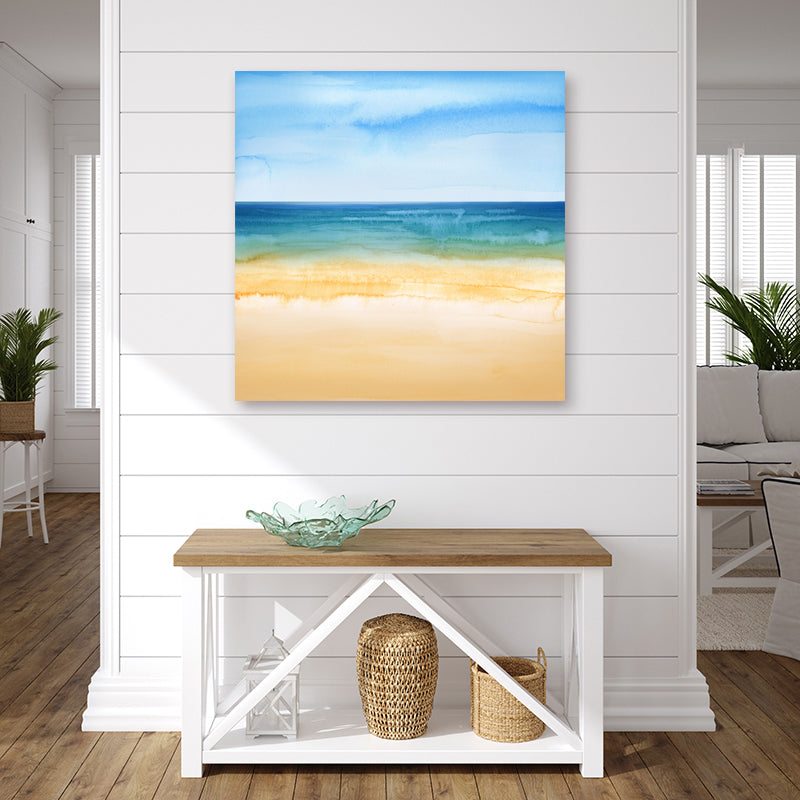 Watercolour wall art print of a turquoise sea, coral sandy beach and clear azure blue sky, in a coastal-style interior.