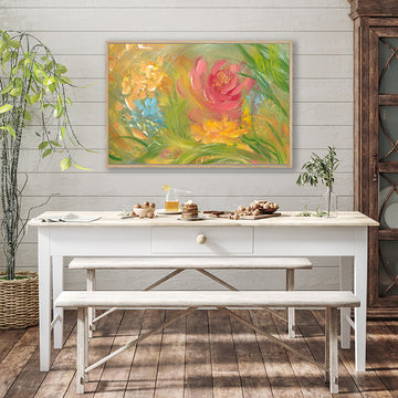 Art print in fresh green hues of spring foliage, and pink and orange flowers, in a rustic country-style interior.