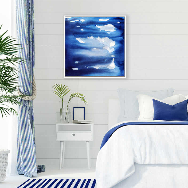 Navy blue and white abstract canvas art print in a crisp white and blue Hamptons style bedroom.