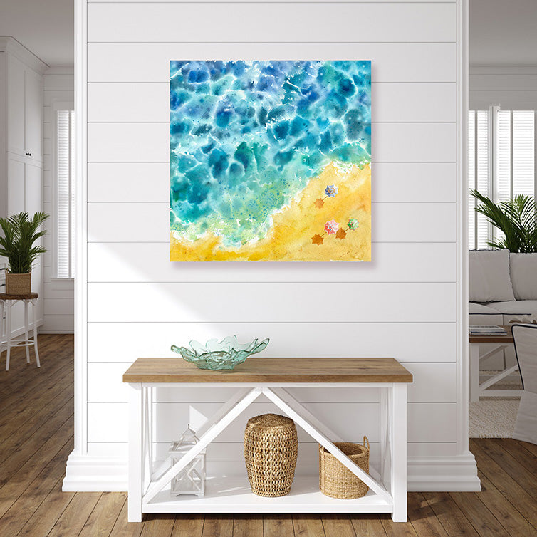 Beach art print of an aqua blue sea, golden sand, and colourful umbrellas in a beachy style interior.