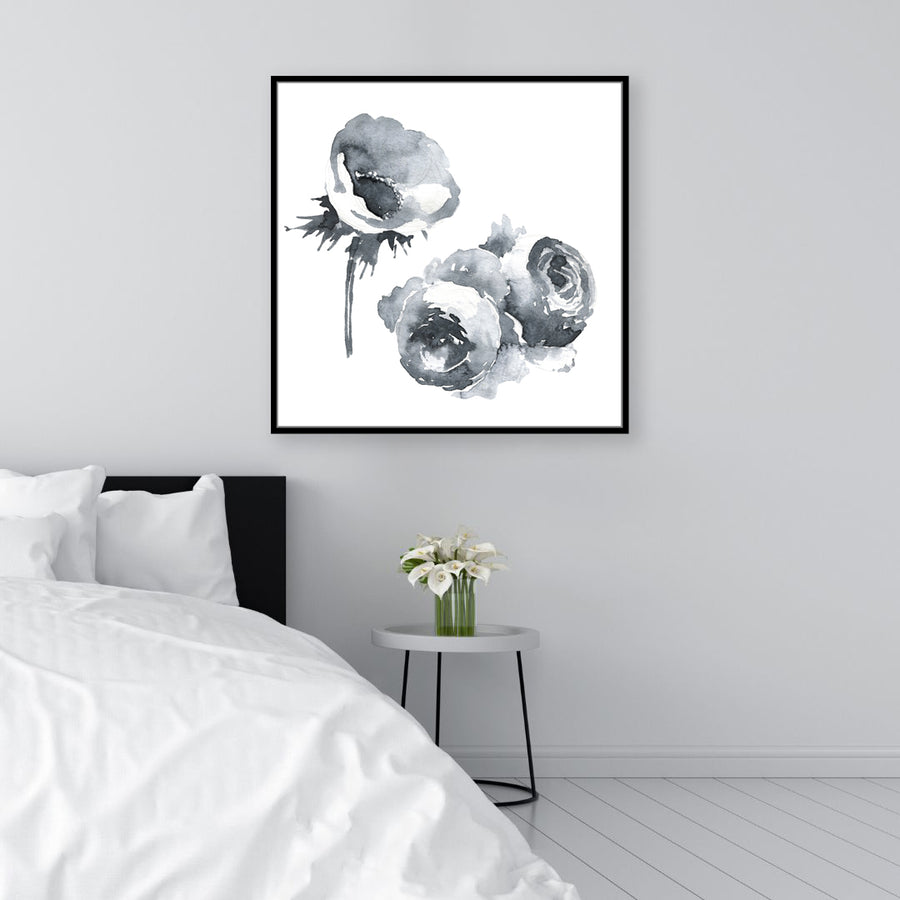 Black and white wall art print of flowers on a white background, displayed in a monochrome minimalist bedroom.