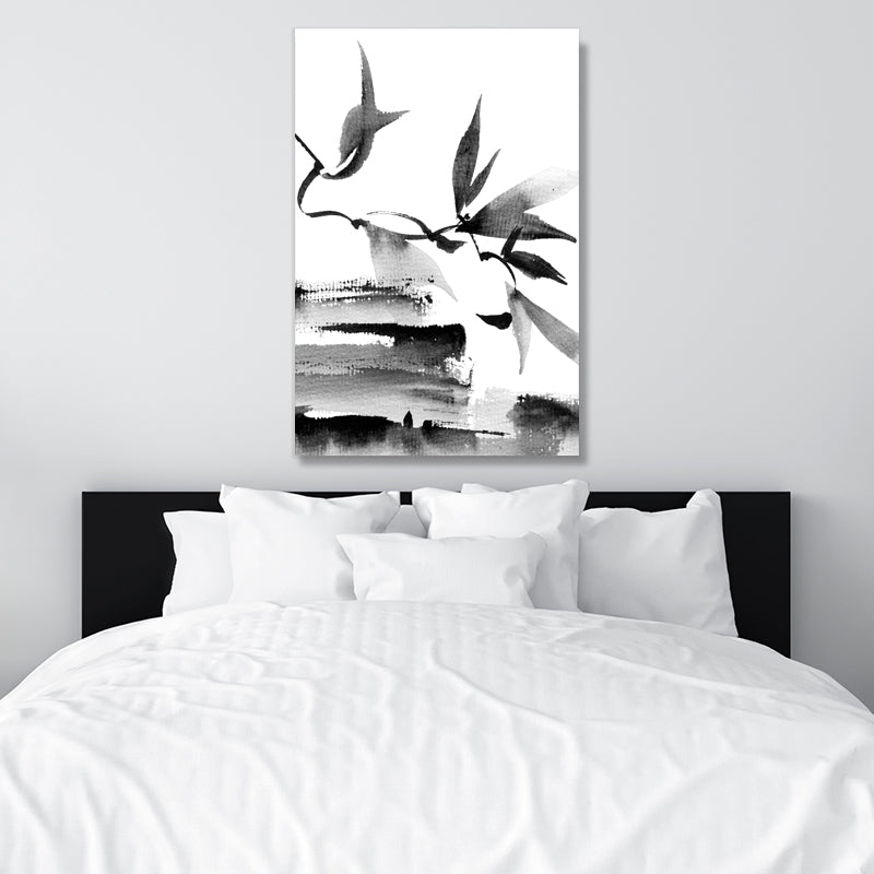 Black and white Japanese ink wall art print of leaves and branches, in a monochrome, minimalist bedroom.