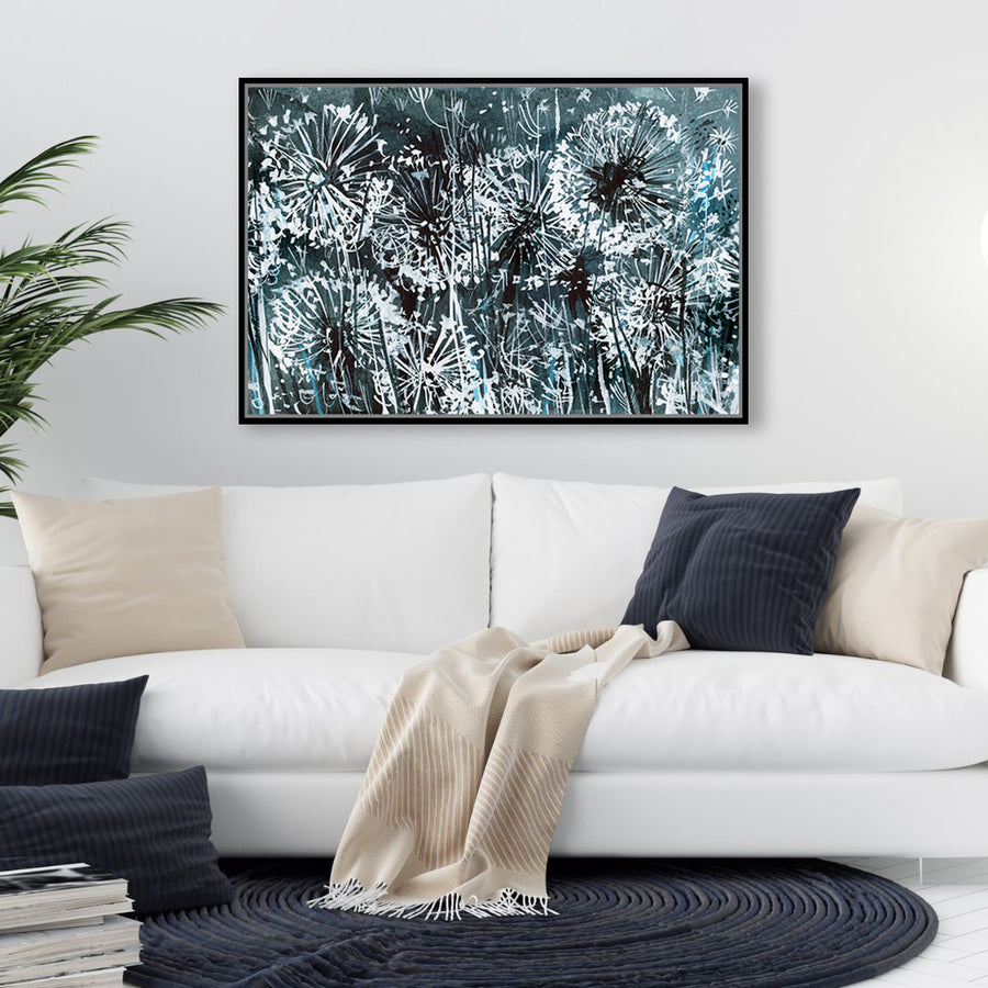 Inky black and white canvas art print of dandelions bathed in the glow of moonlight, in a minimalist-style living room.