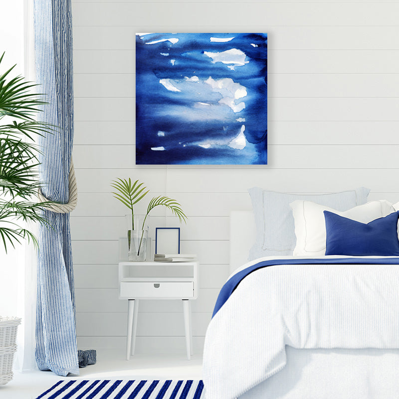 Art print of navy blue storm clouds, in a crisp white and blue Hamptons style bedroom.