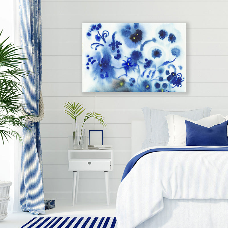 Canvas wall art print of navy blue flowers, produced by ink droplets, in a blue and white Hamptons-style bedroom.