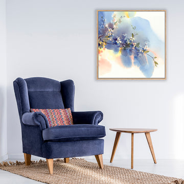 Indigo blue and white floral watercolor art print next to a navy blue velvet armchair in a Hamptons-style sitting room.