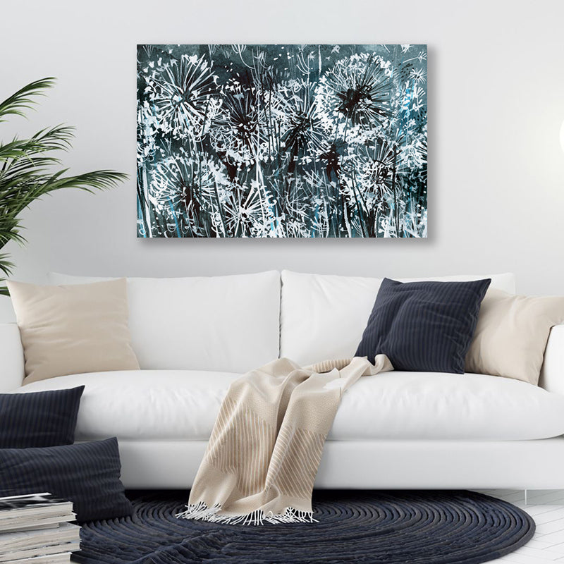 Inky black and white wall art print of dandelions bathed in the glow of moonlight, in a minimalist-style living room.