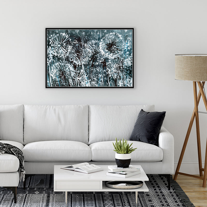 Canvas wall art print in inky black and white depicting dandelions glowing in the moonlight, in a minimalist interior. 