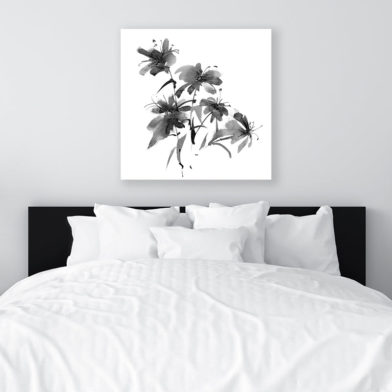 Black and white floral canvas art print inspired by Japanese ink artwork displayed in a minimalist bedroom. 