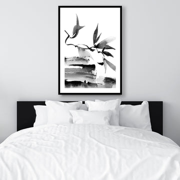 Black and white Japanese ink framed art print of leaves and branches, in a monochrome, minimalist interior.