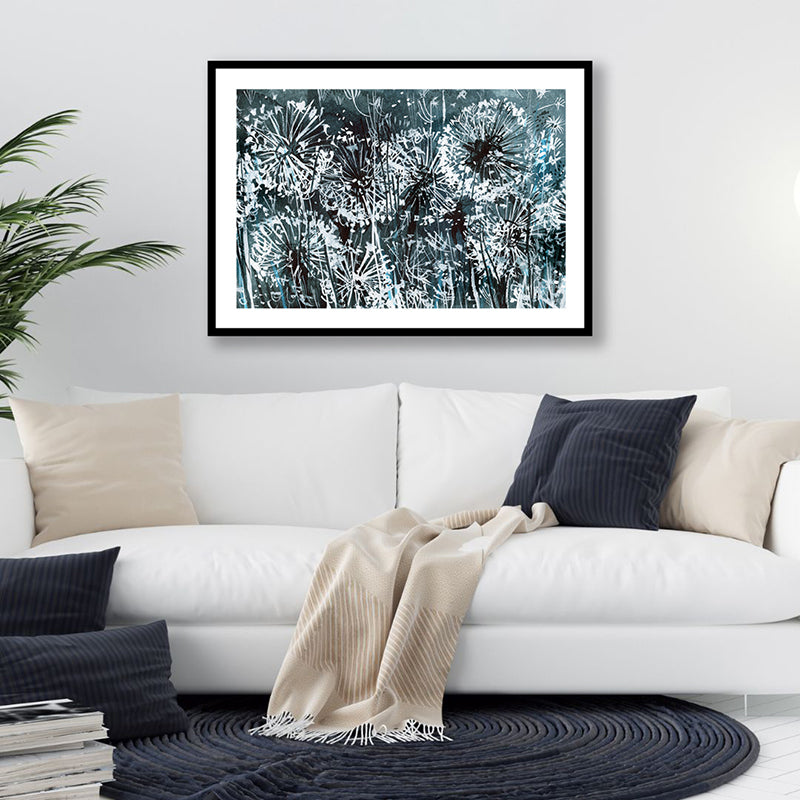 Inky black and white framed art print of dandelions bathed in the glow of moonlight, in a minimalist-style living room.