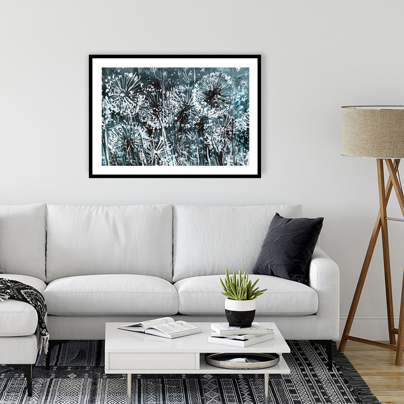 Inky black and white framed art print of dandelions bathed in the glow of moonlight, in a minimalist-style living room. 