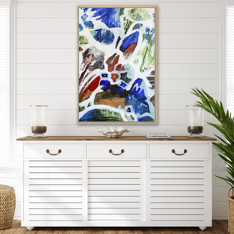 Abstract wall art print featuring navy blue and white, with pops of olive green and rust, in a Hamptons-style interior.