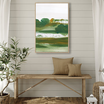 Canvas art print that evokes the beauty of a rural landscape in dark green and olive hues, in a farmhouse-style interior.  