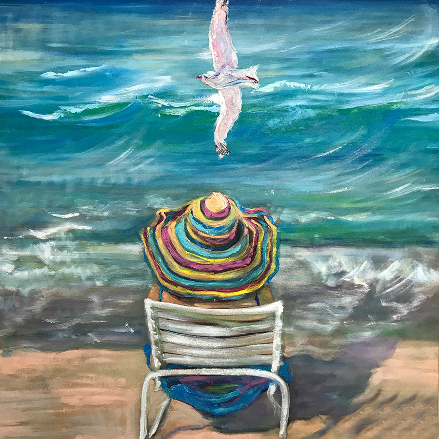 Retro beach artwork of a woman sitting on a beach and gazing out towards a turquoise sea, with a seagull gliding above her.