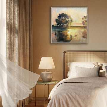 Canvas art print of a river landscape in tan and brown, illuminated by a setting sun, displayed in a country-style interior.