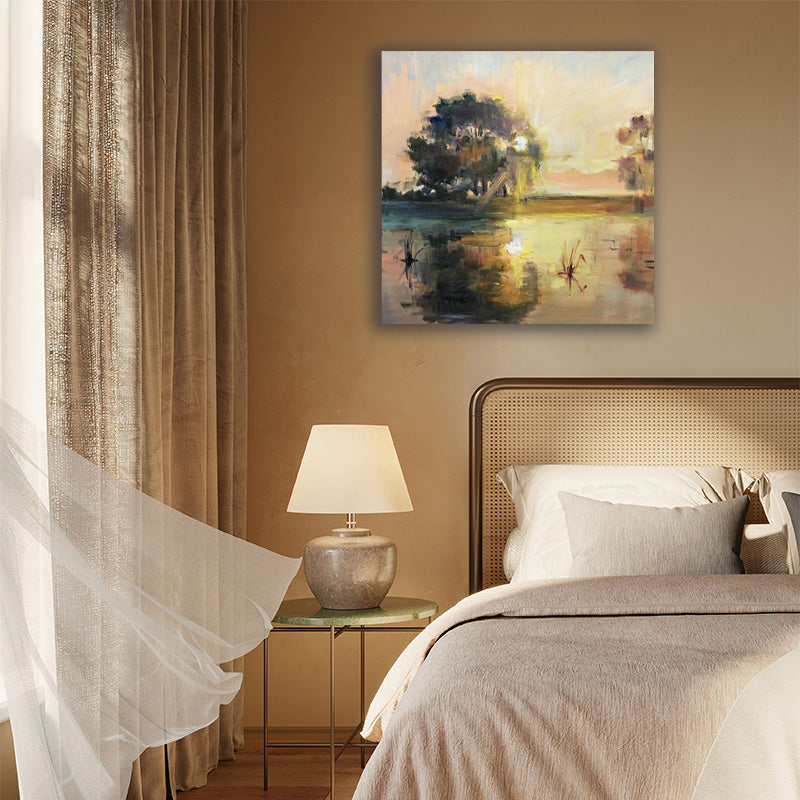 Canvas art print of a river landscape in tan and brown, illuminated by a setting sun, displayed in a country-style bedroom.