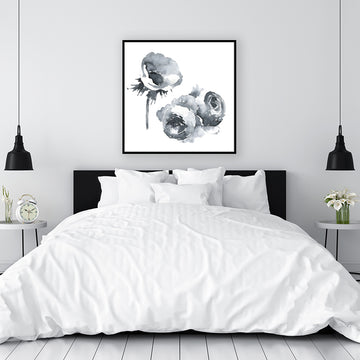 Black and white canvas art print of flowers on a white background, displayed above a bed in a minimalist bedroom.