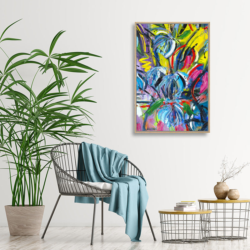 Colourful abstract canvas art print of blue, pink, and yellow tropical flowers in modern, minimalist interior.