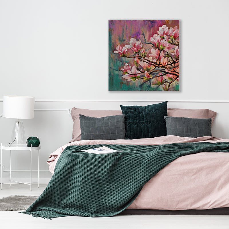 Canvas art print of a magnolia tree branch laden with pink blossoms in a white, pink and emerald green bedroom interior.