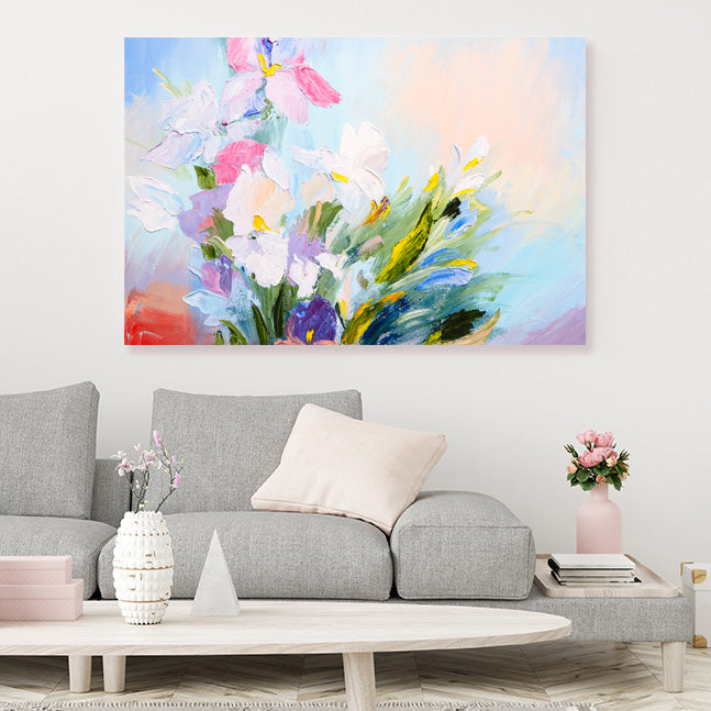 Impressionist floral canvas art print in white, pink and mauve, with a blue sky background., in a pale grey scandinavian style living room.