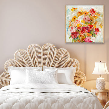 Art print of red, orange and pink flowers in bohemian style bedroom.